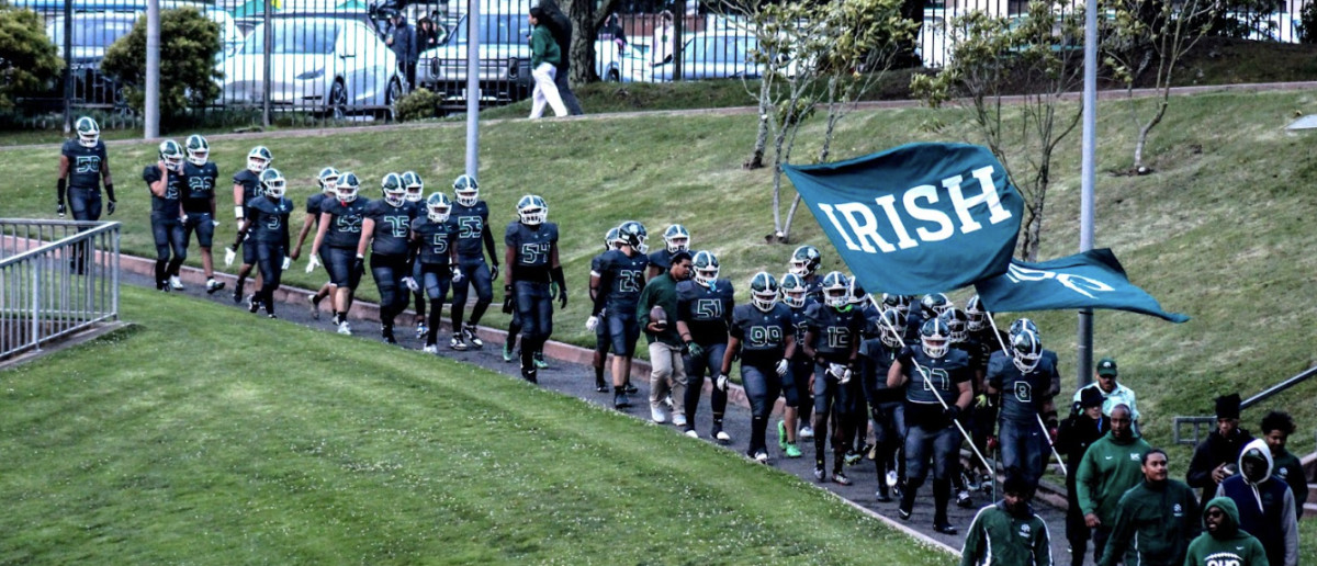 The team walks down to the field with Irish flags raised high!